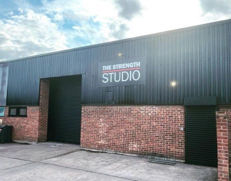 Industrial unit with its metal cladding sprayed RAL 9005 black to match the gym inside