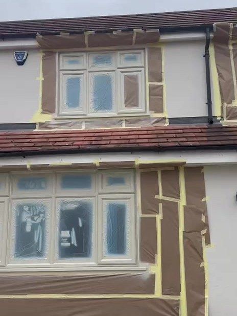 Loughborough house with its windows masked and sheeted in paper and tape ready for spraying