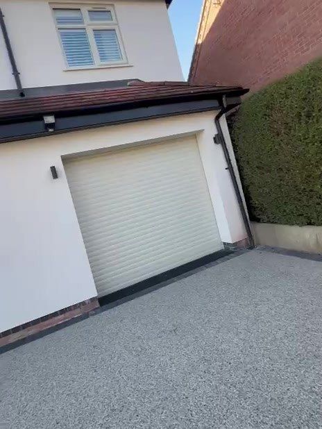 Roller garage door in Loughborough after being sprayed pale cream