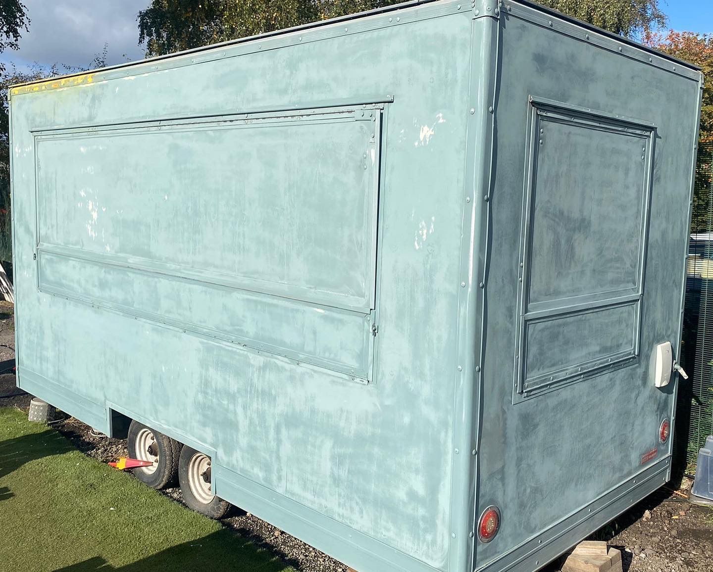 Spray Maestro scuffing the surface of a food trailer before commercial paint spraying in Nottingham