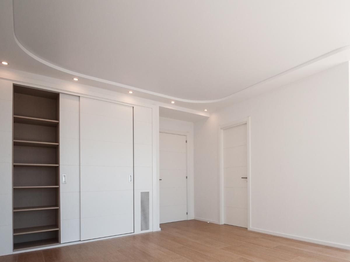 Spray Maestro after spray painting fitted wardrobes and bedroom doors to white in a bedroom