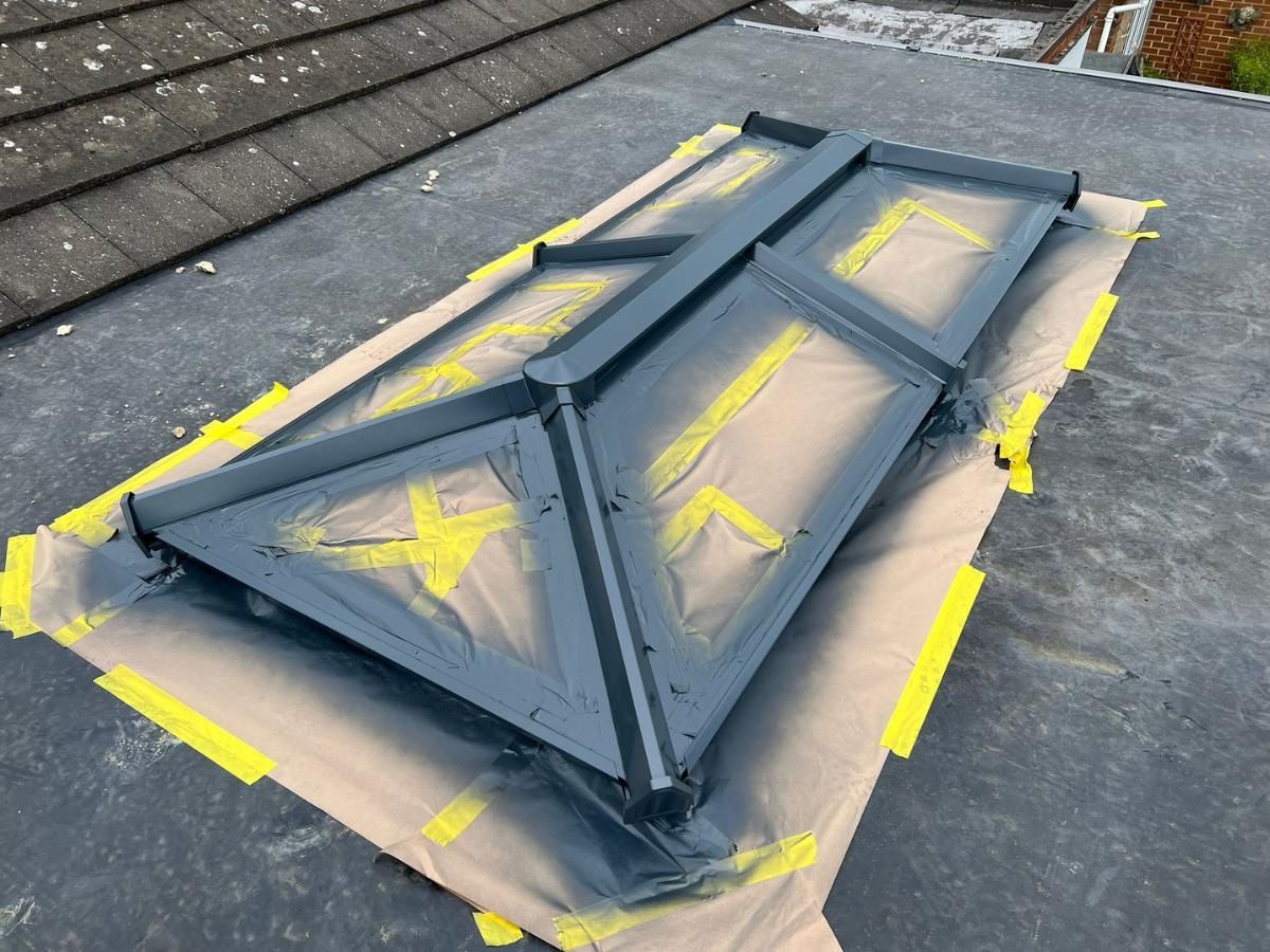 Spray Maestro spray painting a conservatory roof lantern before masking removed