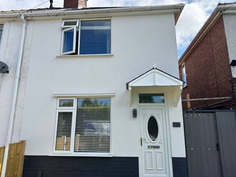 Semi-detached house in Sutton-in-Ashfield with white uPVC windows and front door before spraying