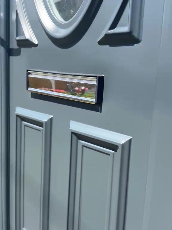 Close-up of the raised panels and chrome letterplate on a uPVC front door sprayed anthracite grey in Sutton-in-Ashfield