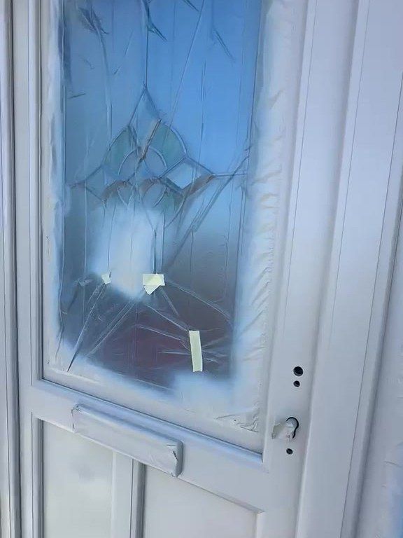 uPVC front door in Ashby-de-la-Zouch with its leaded glass sheeted during spraying