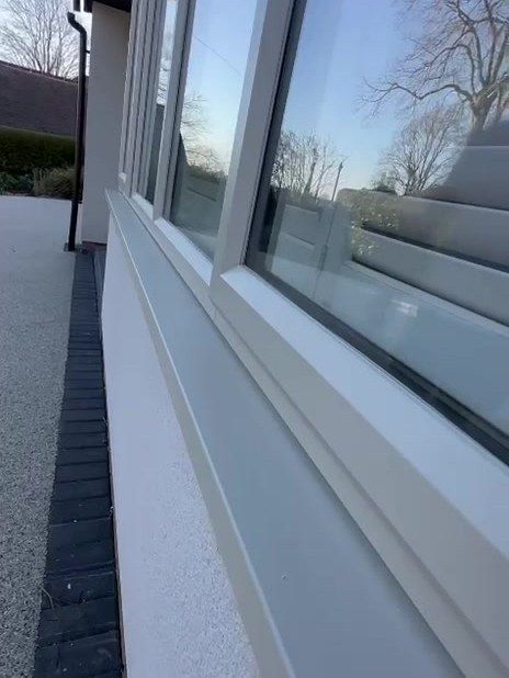 Close-up of a uPVC window frame sprayed pale cream in Loughborough