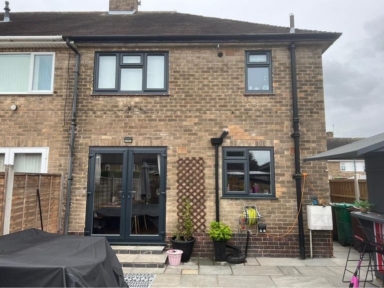 The same rear elevation after the windows and French doors were sprayed anthracite grey