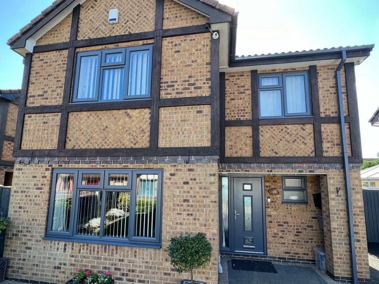 The same house after its uPVC windows and front door were sprayed charcoal grey