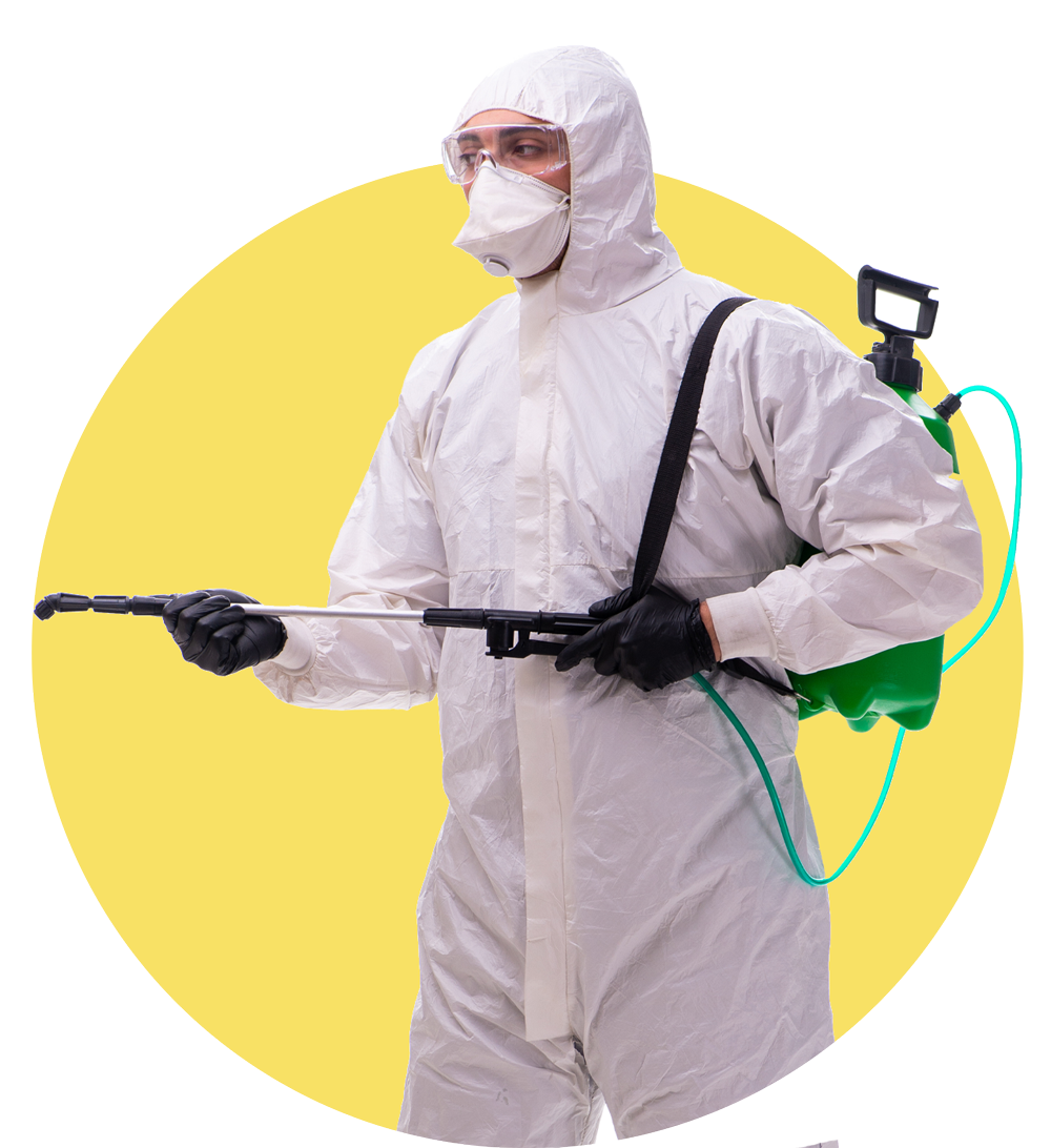 A man in a protective suit is spraying something with a sprayer.