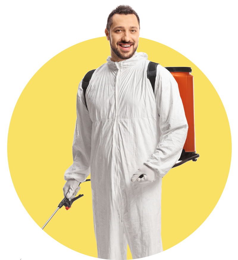 A man in a white coverall is holding a sprayer. A man in a white coverall is holding a sprayer.