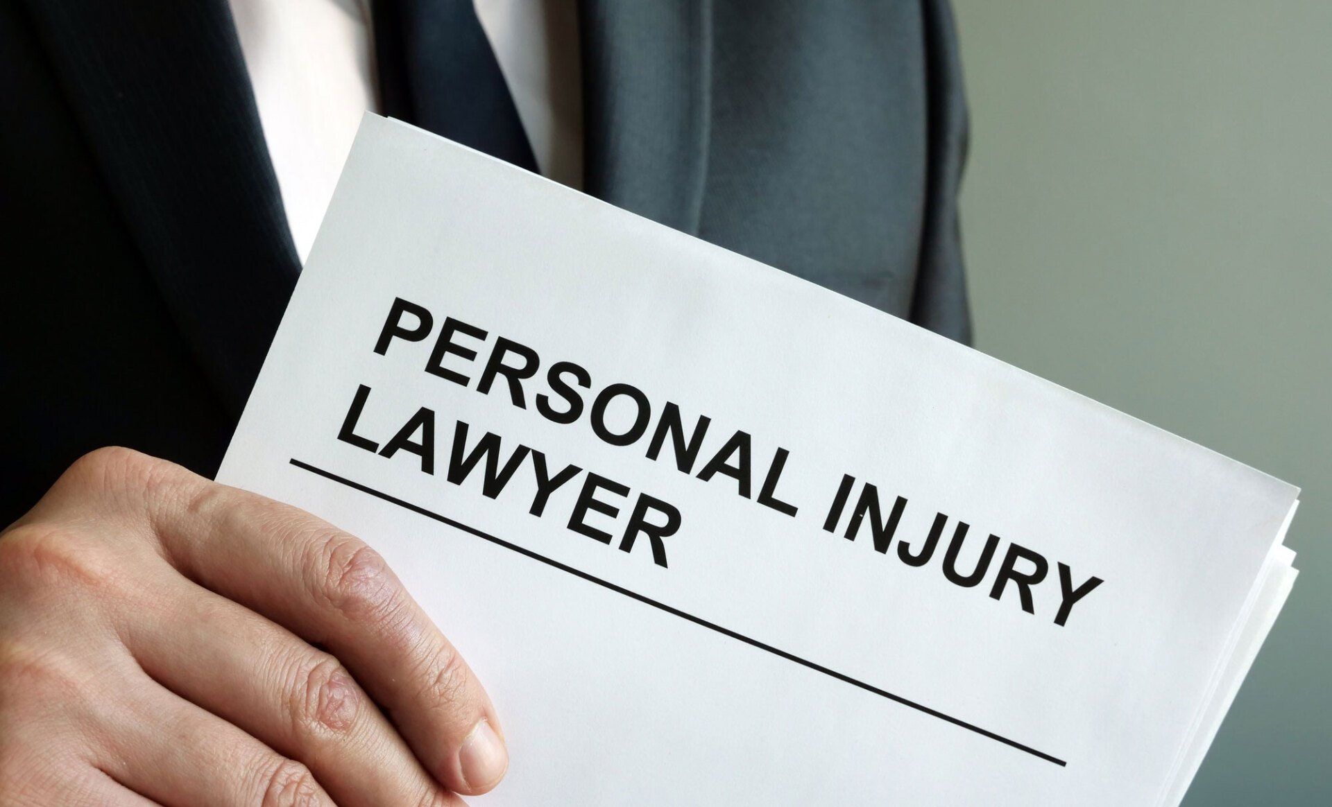 Personal Injury Lawyer Holding Paper — Goshen, NY — Owen Law Firm PLLC Personal Injury Lawyer Holding Paper — Goshen, NY — Owen Law Firm PLLC