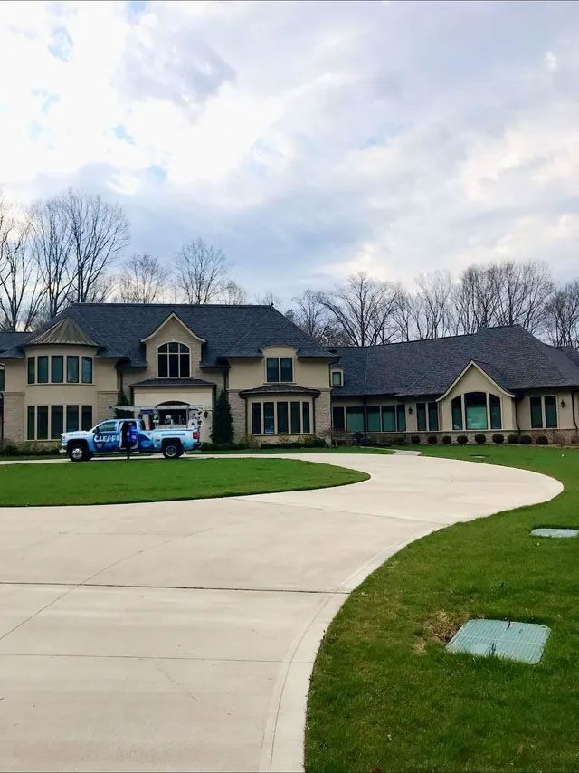 Blue truck parked on a clean driveway