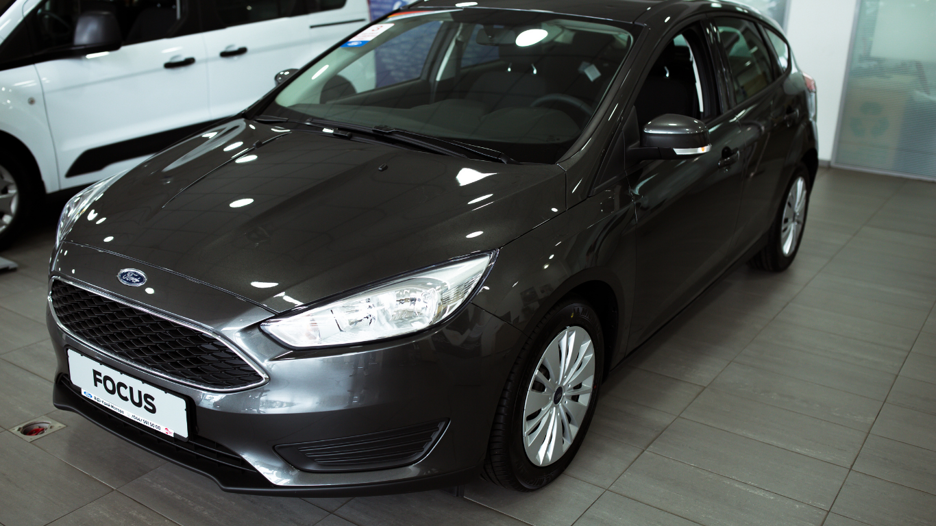 Dark gray Ford Focus hatchback parked indoors on a showroom floor