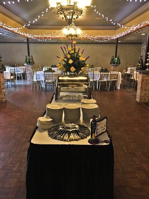 A large room with tables and chairs and a buffet table