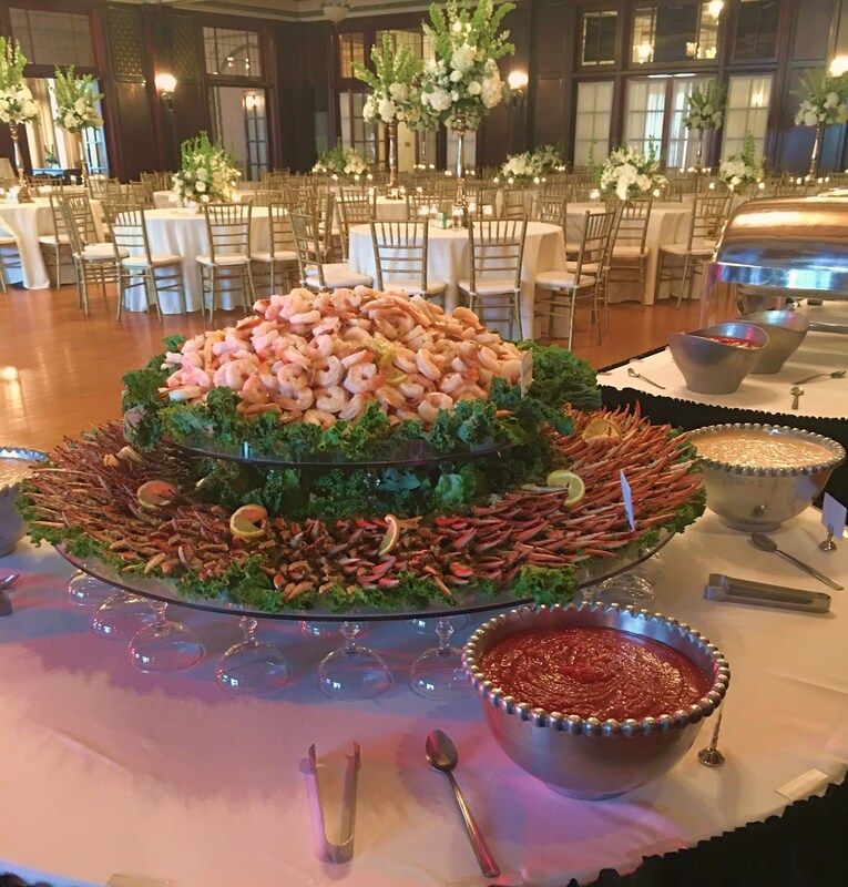 A buffet table with shrimp and other food on it