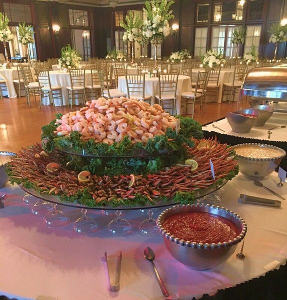 A buffet table with shrimp and other food on it