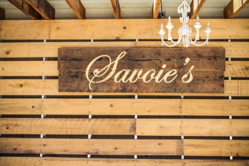 A wooden wall with a sign that says ' savoie 's ' on it.