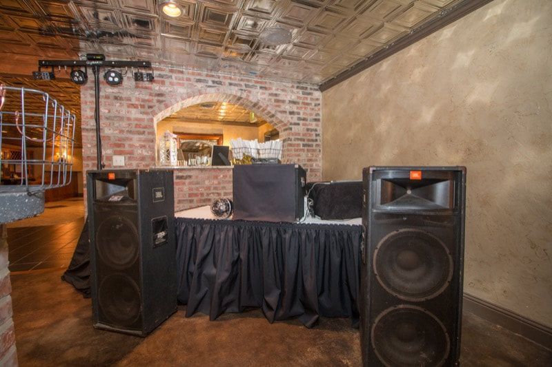 A room filled with speakers and a dj booth.