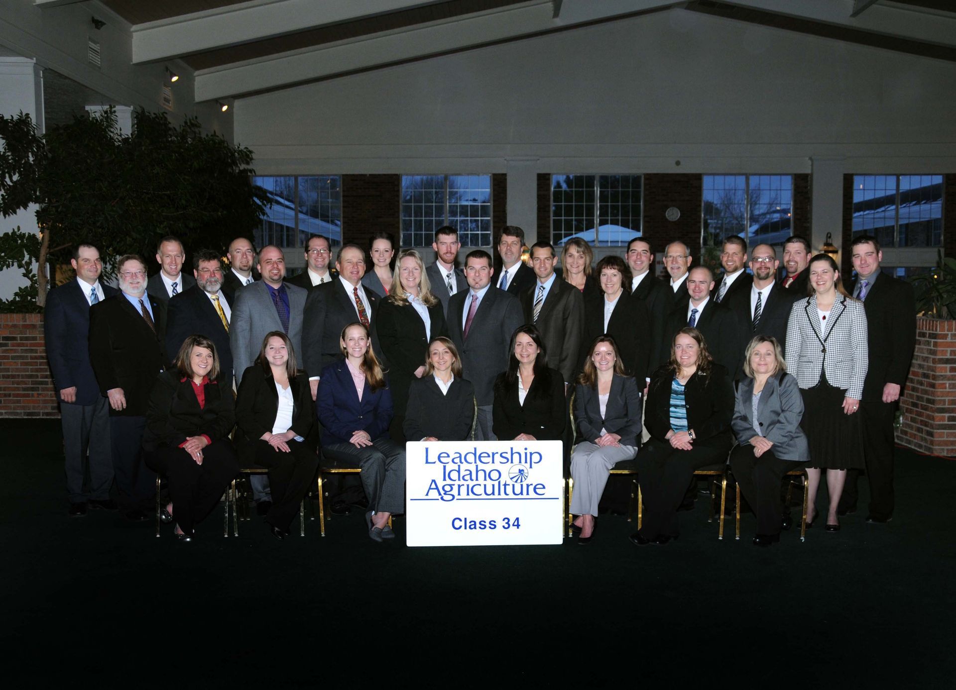 Group photo of Leadership Iowa Agriculture Class 34 participants posed in formal wear in a conference room.
