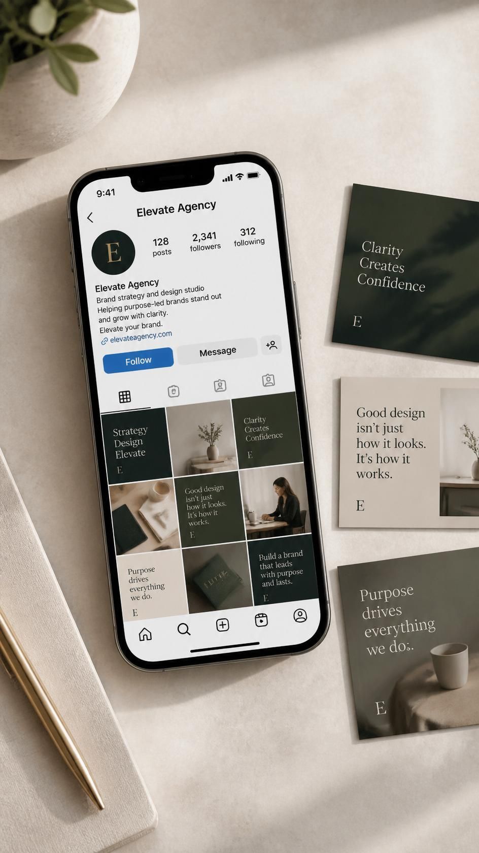 Smartphone on a desk showing an Instagram profile grid, beside green and beige minimalist cards and a notebook.