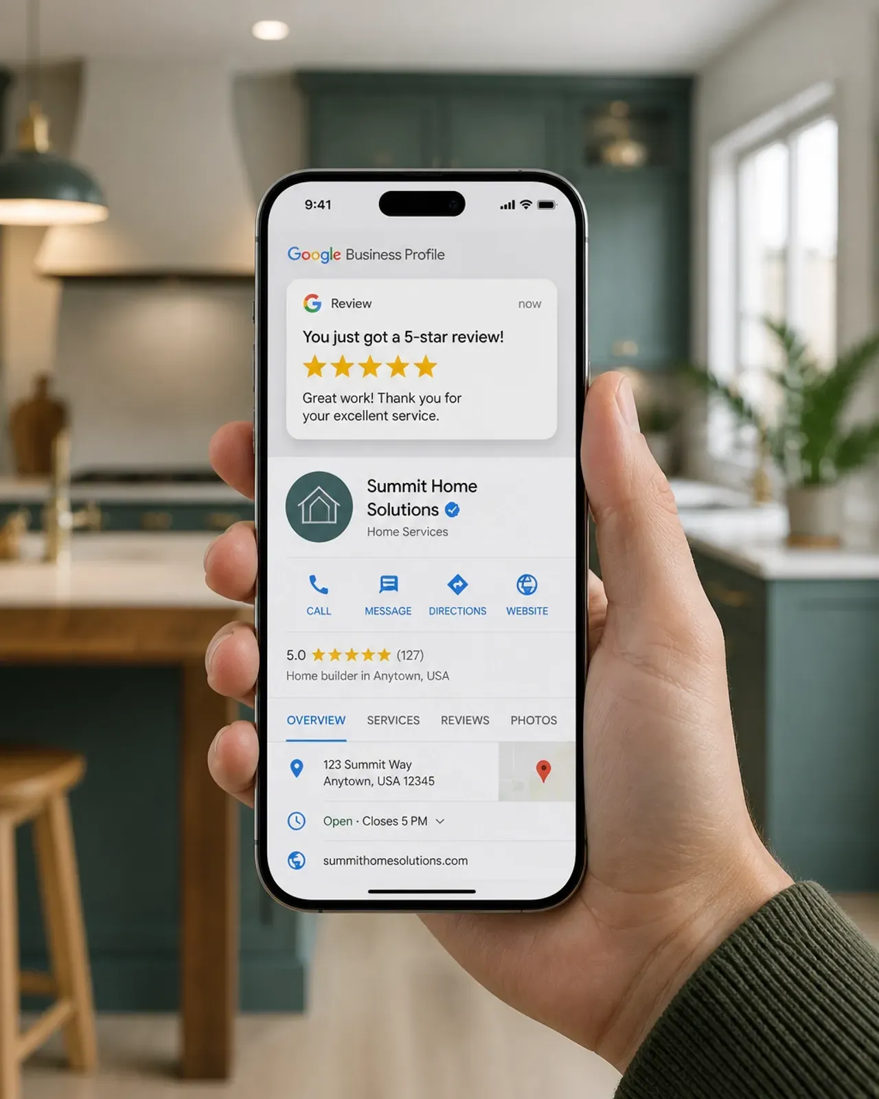 Hand holding a smartphone showing a home services app in a cozy kitchen with a blurred background