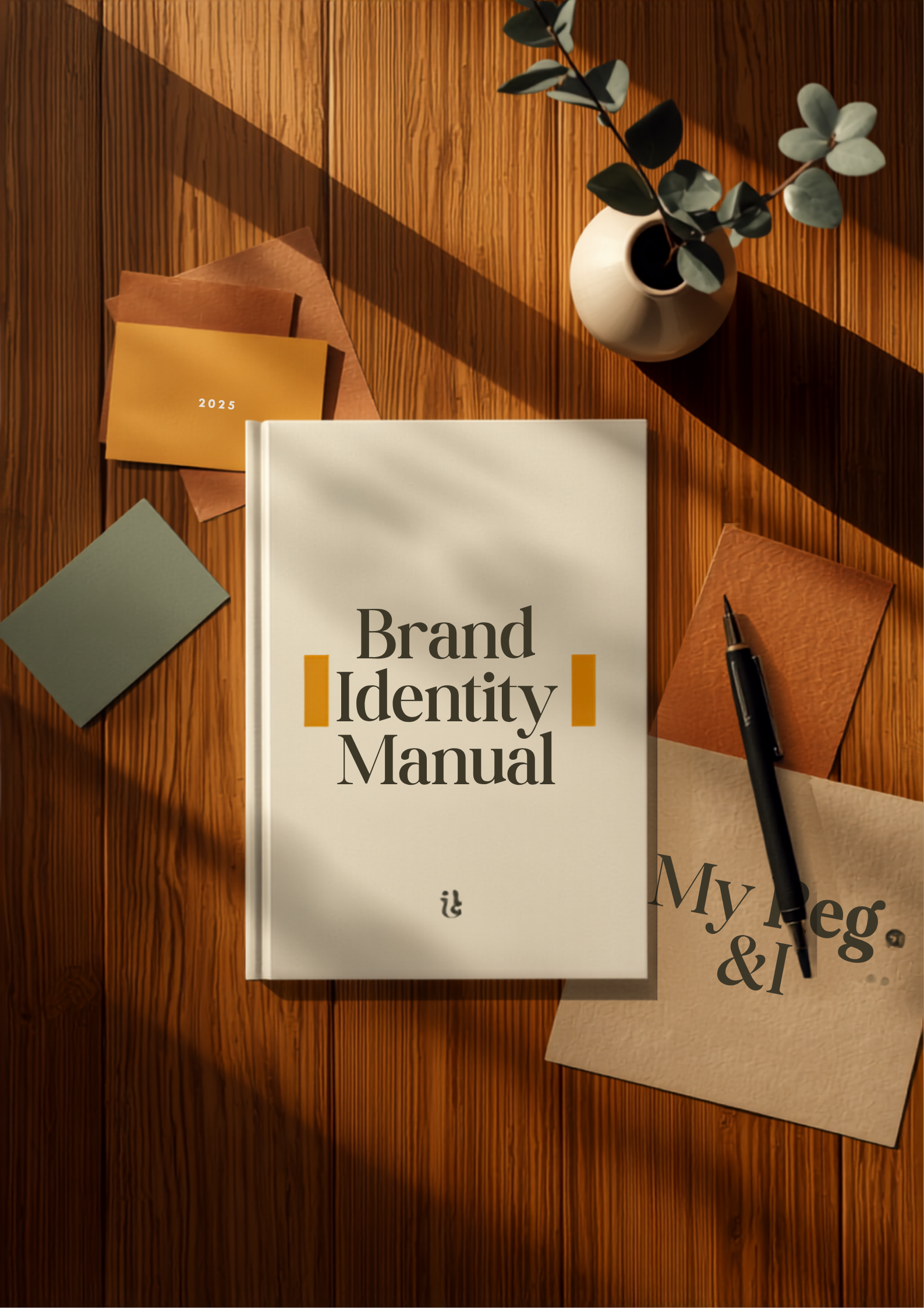 Brand Identity Manual on wooden desk with papers, pens, and plant in warm sunlight