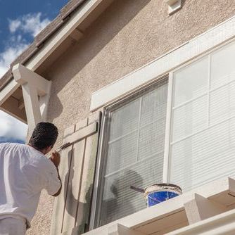 Man Painting A Shutter