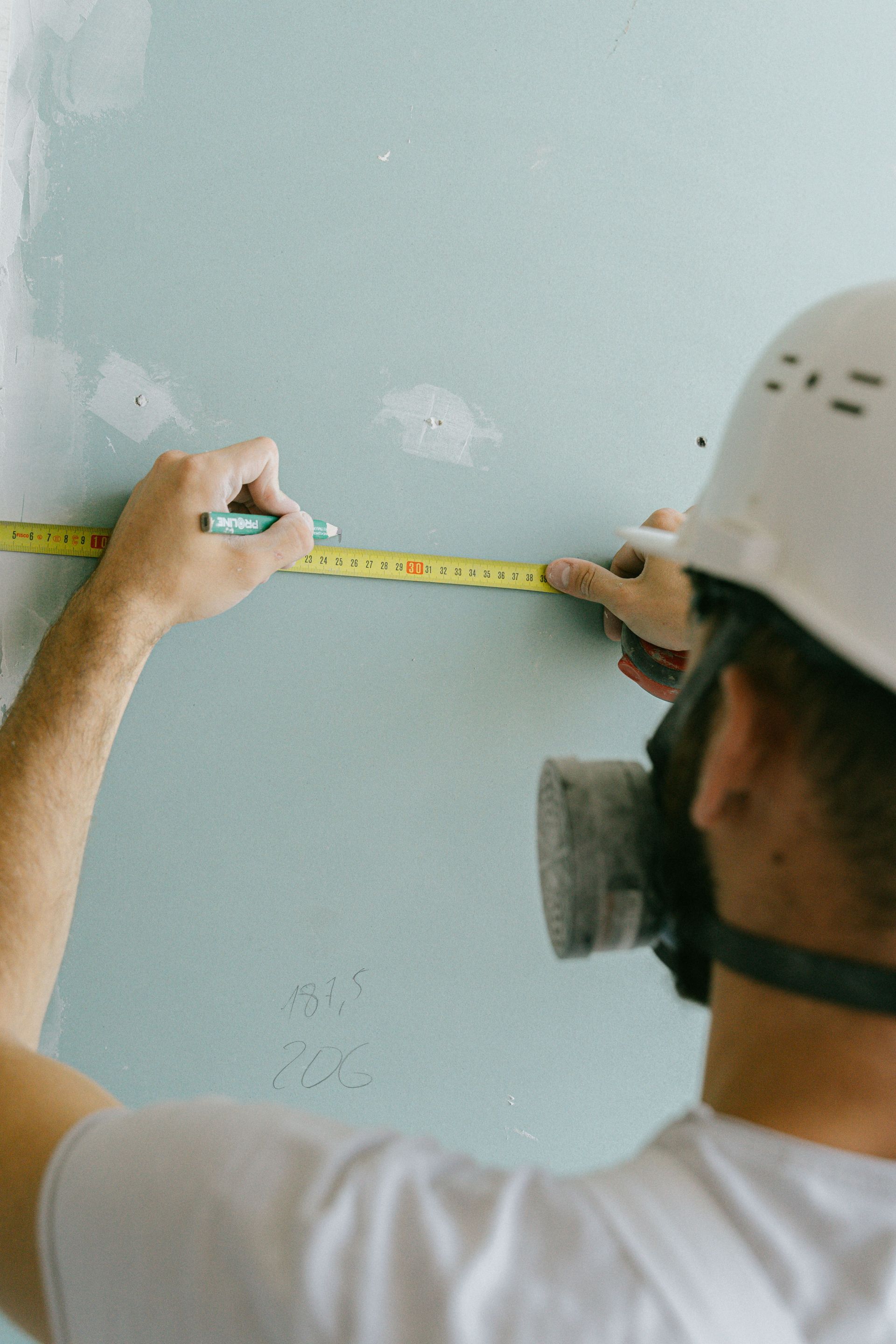 Measuring a wall during an on-site walkthrough