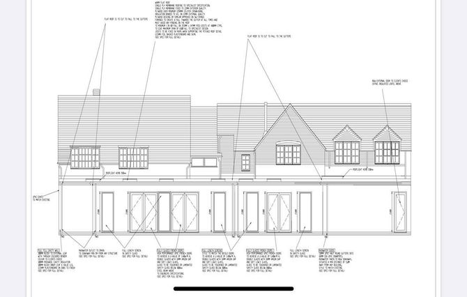 A black and white drawing of a house with a lot of windows