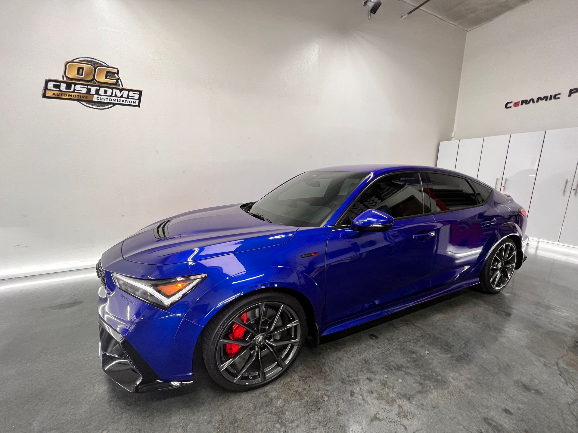 A blue car is parked in a showroom.