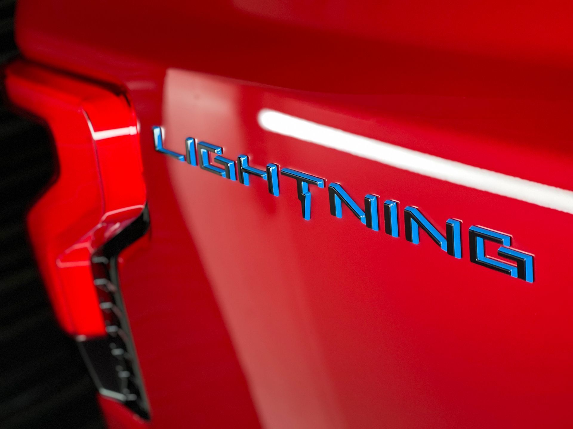 The word lightning is on the side of a red truck