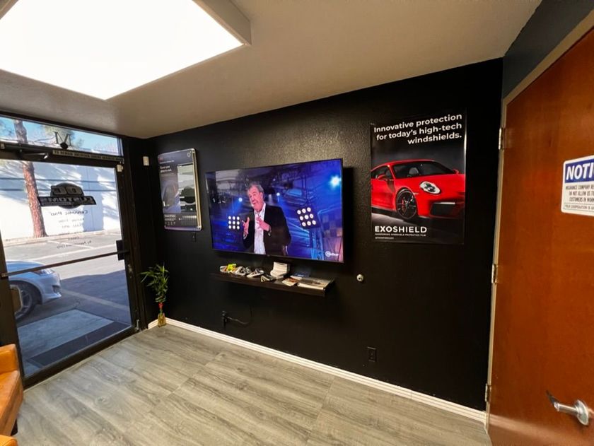A room with a large flat screen tv on the wall.
