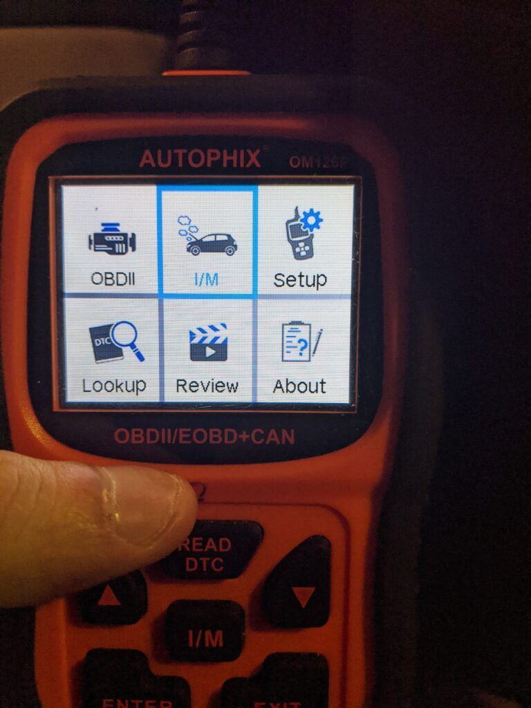 A person is holding an orange autophix device