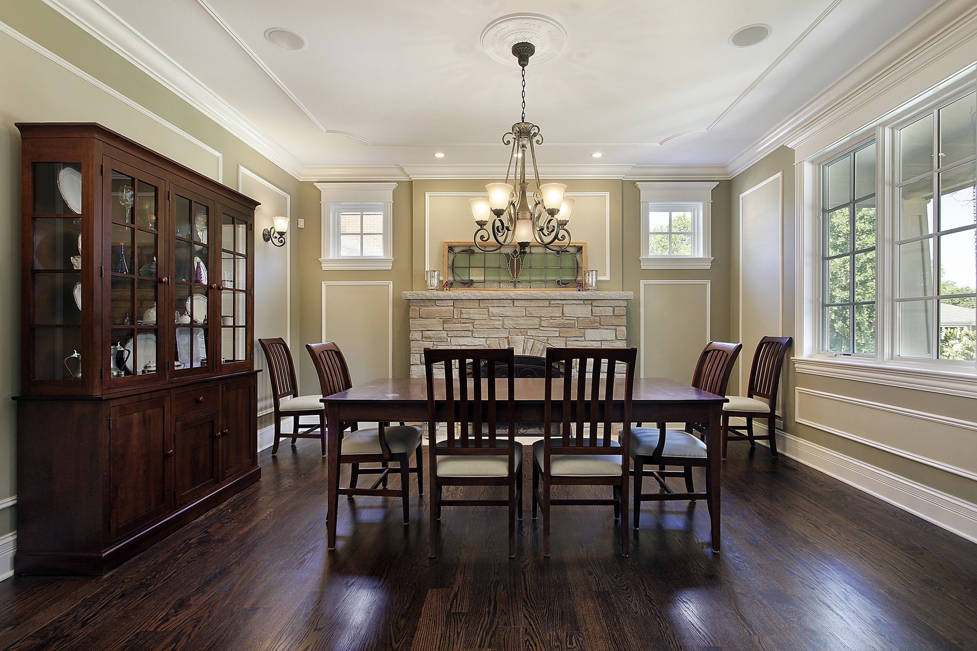 A dining room with a table and chairs and a fireplace