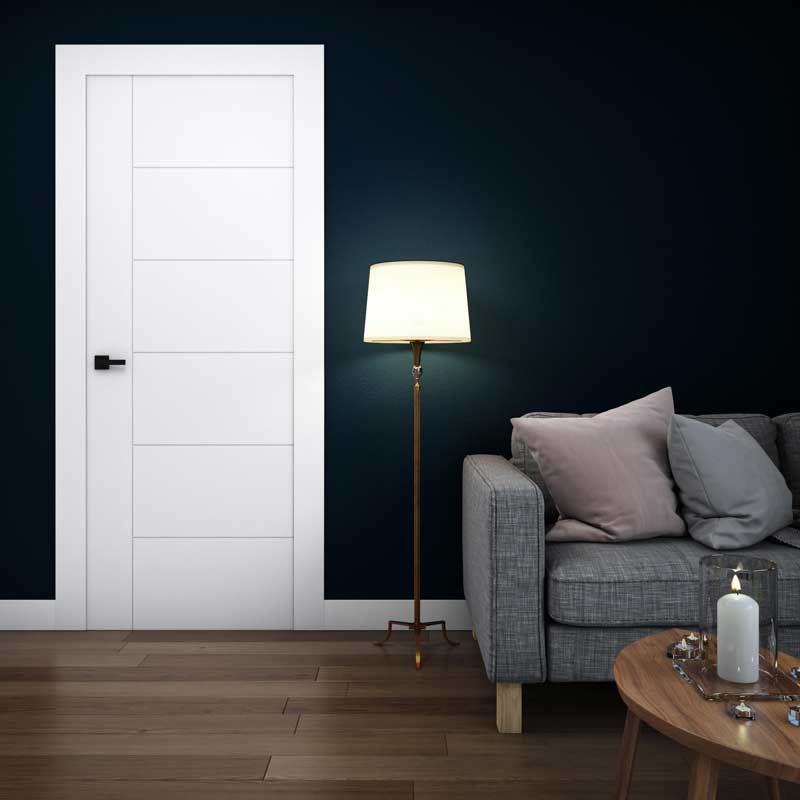 A room with three white doors and a wooden floor.