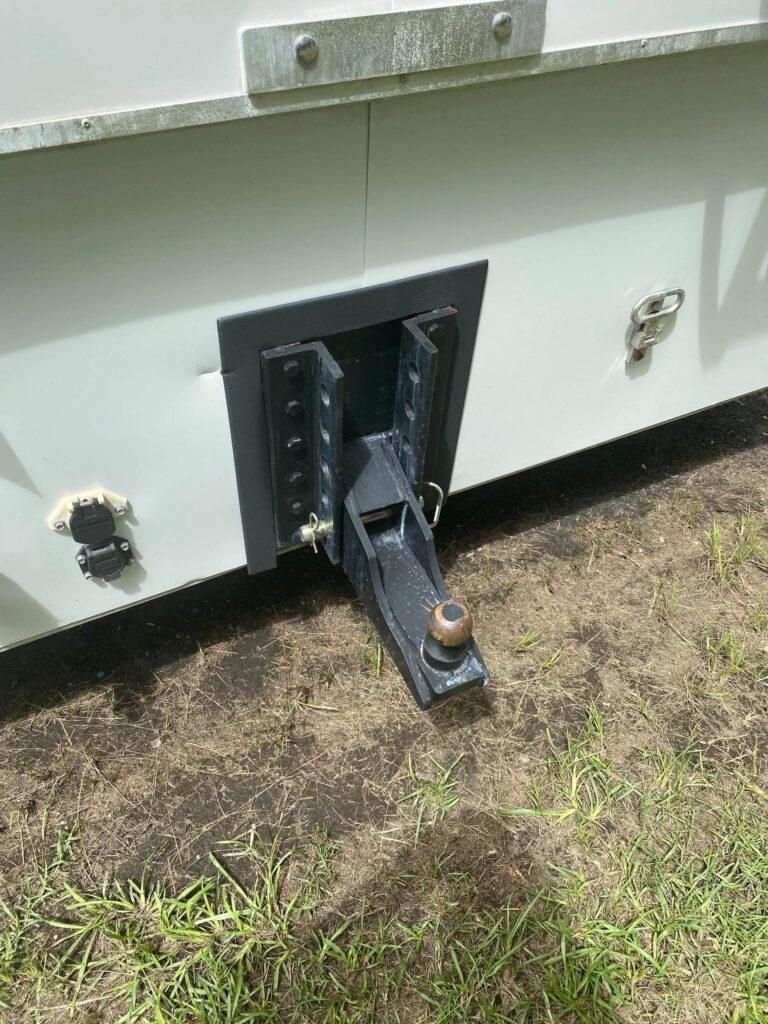 Gray trailer with a dark gray tow hitch assembly and ball. | Dave Muller Automotive & Trailer