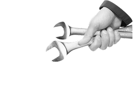 Hand holding two open-end wrenches, against a white background. | Dave Muller Automotive & Trailer
