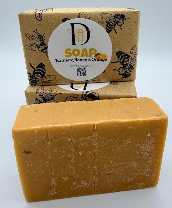 Unwrapped Turmeric, Honey & Orange soap bar in a natural golden-orange color
