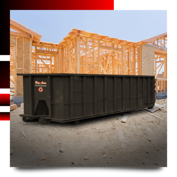 Dumpster in front of a house with graphics behind it.