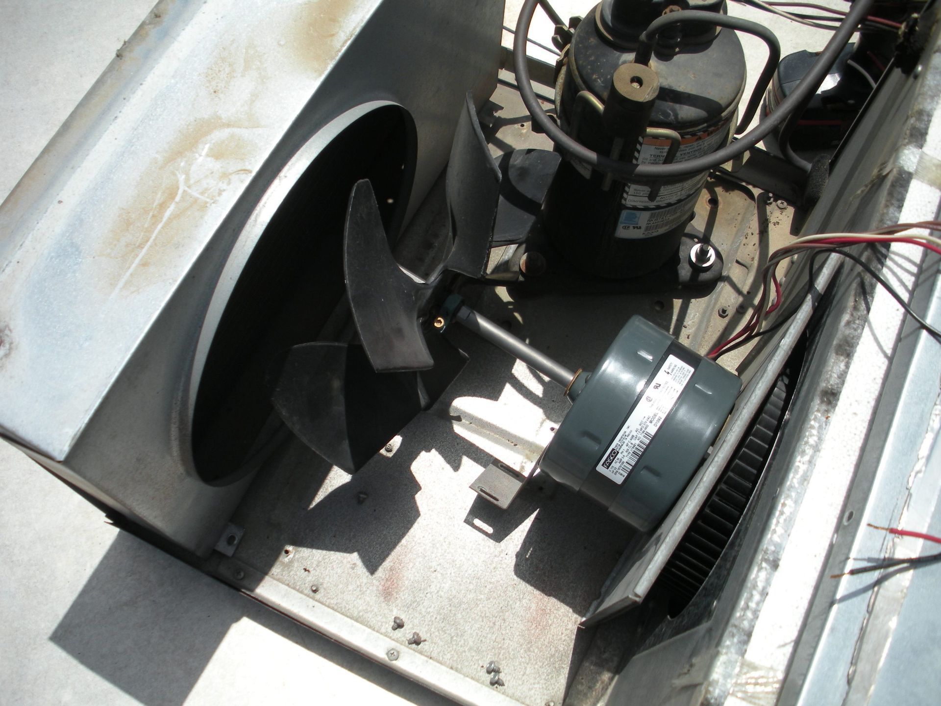 A green fan is sitting on top of a white box.