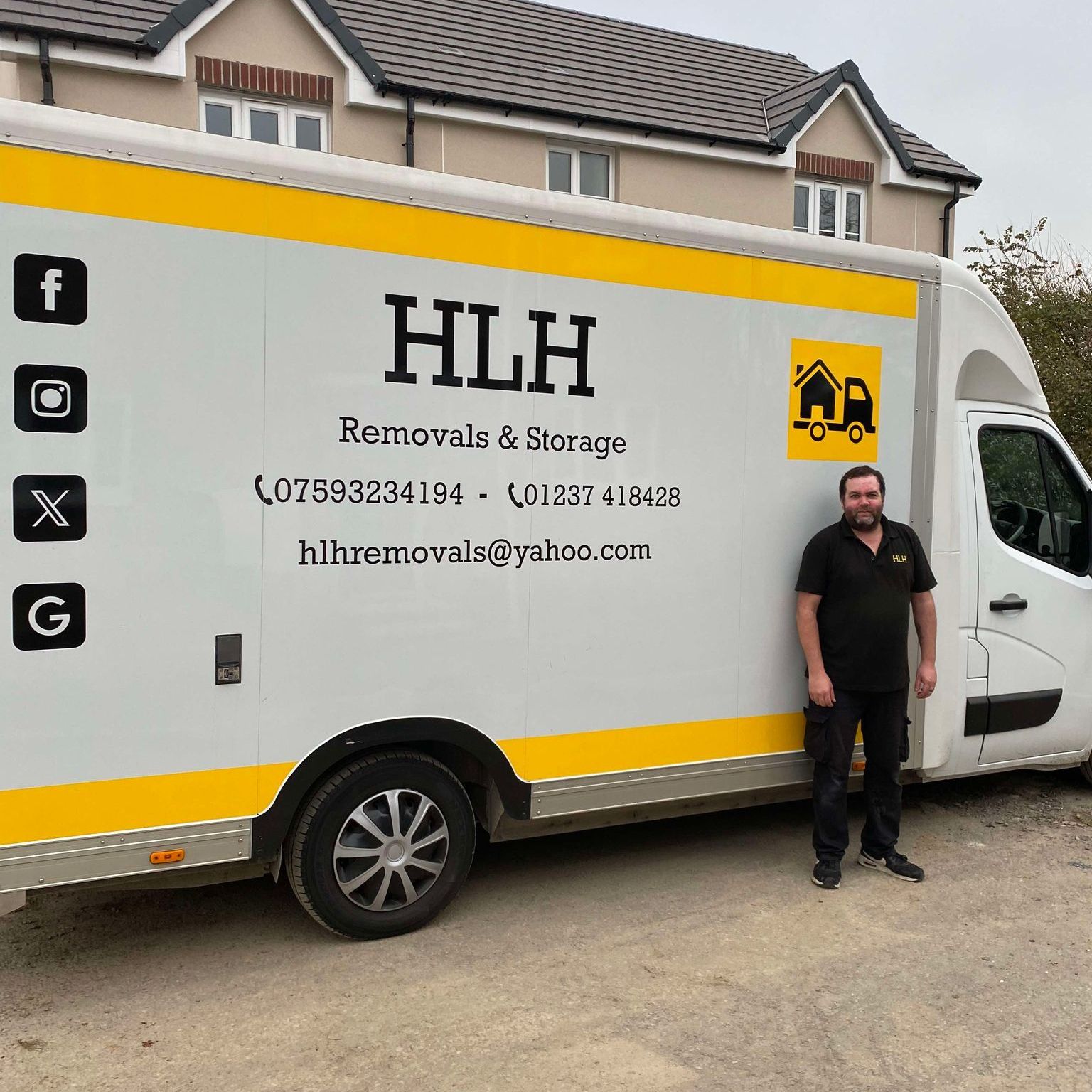 HLH Removals & Storage van parked outside a house, with a man standing beside it.