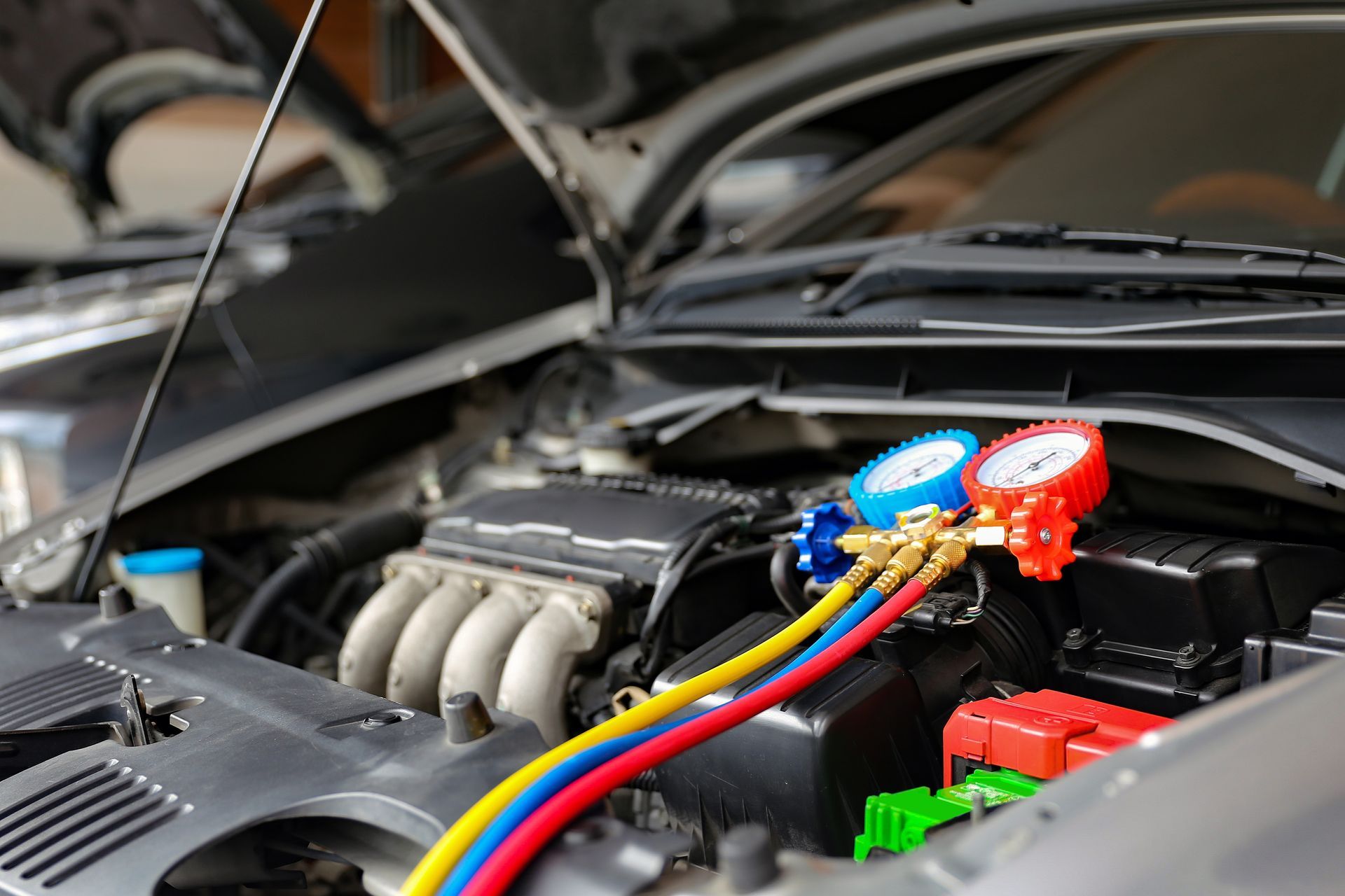 A close up of a car engine with the hood open.