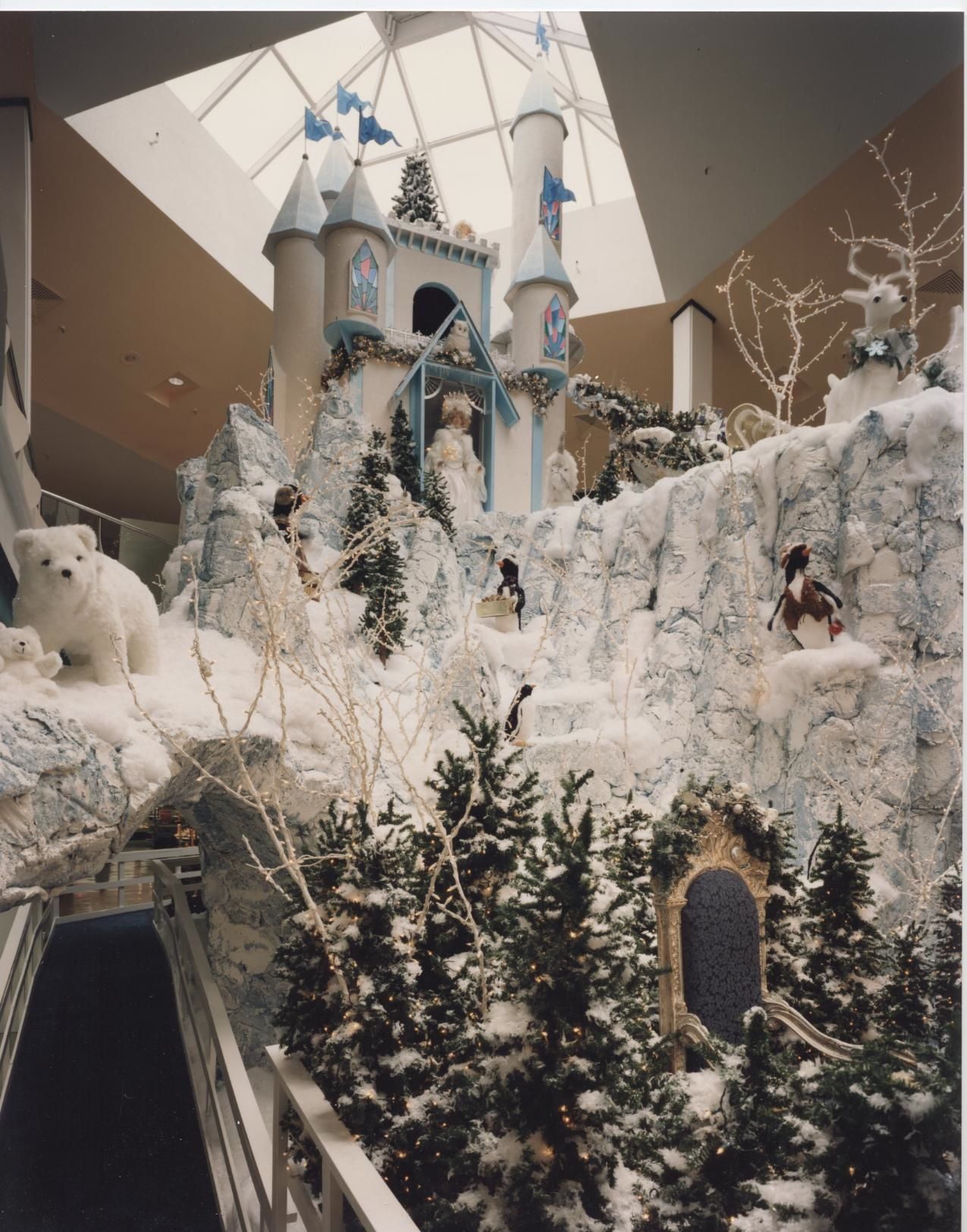 Winter wonderland scene with castle, polar bears, penguins, and snowy trees.