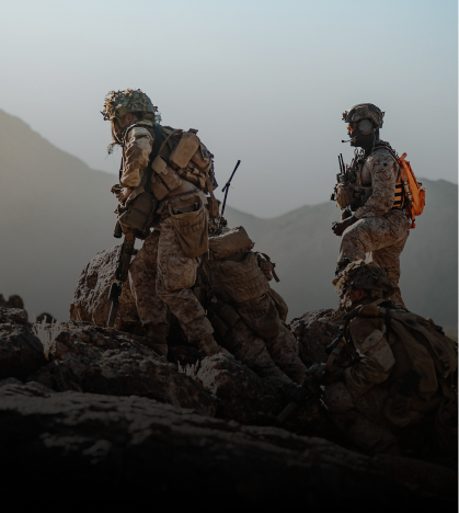 Two soldiers are standing on top of a mountain