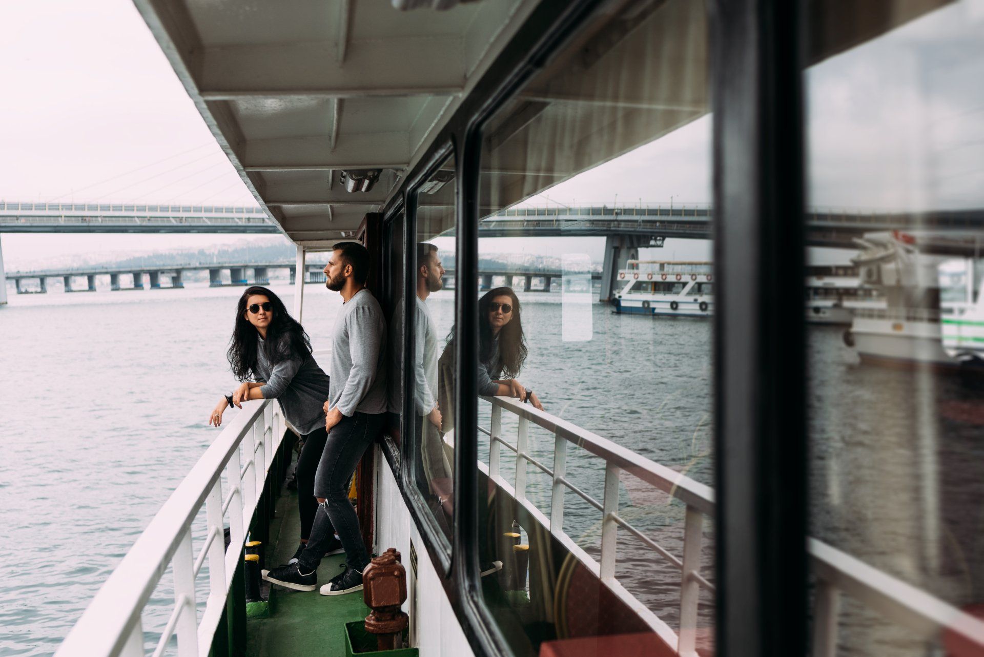 a guy and a girl standing on board a cruise