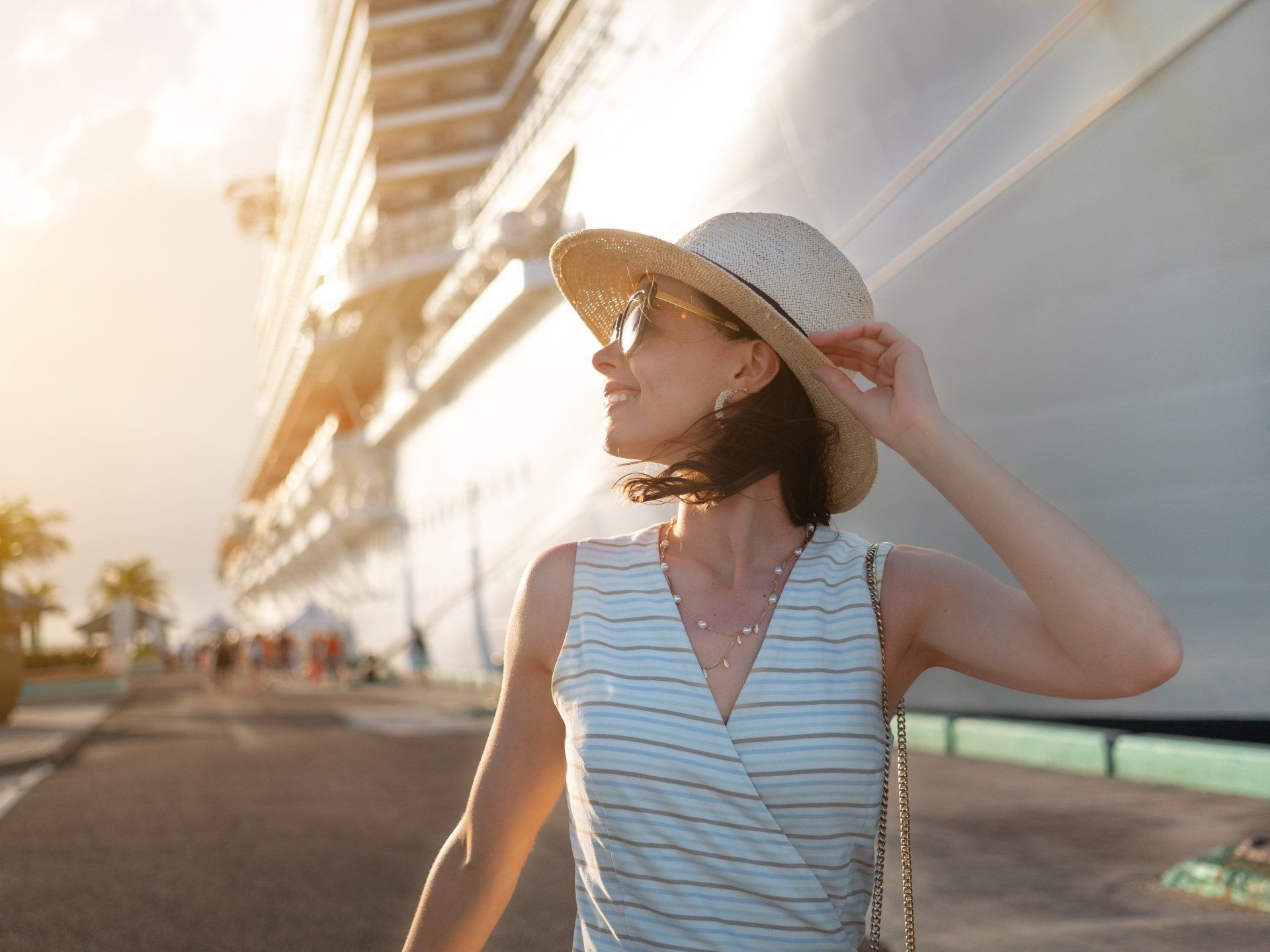 a happy young woman with a boat in the background