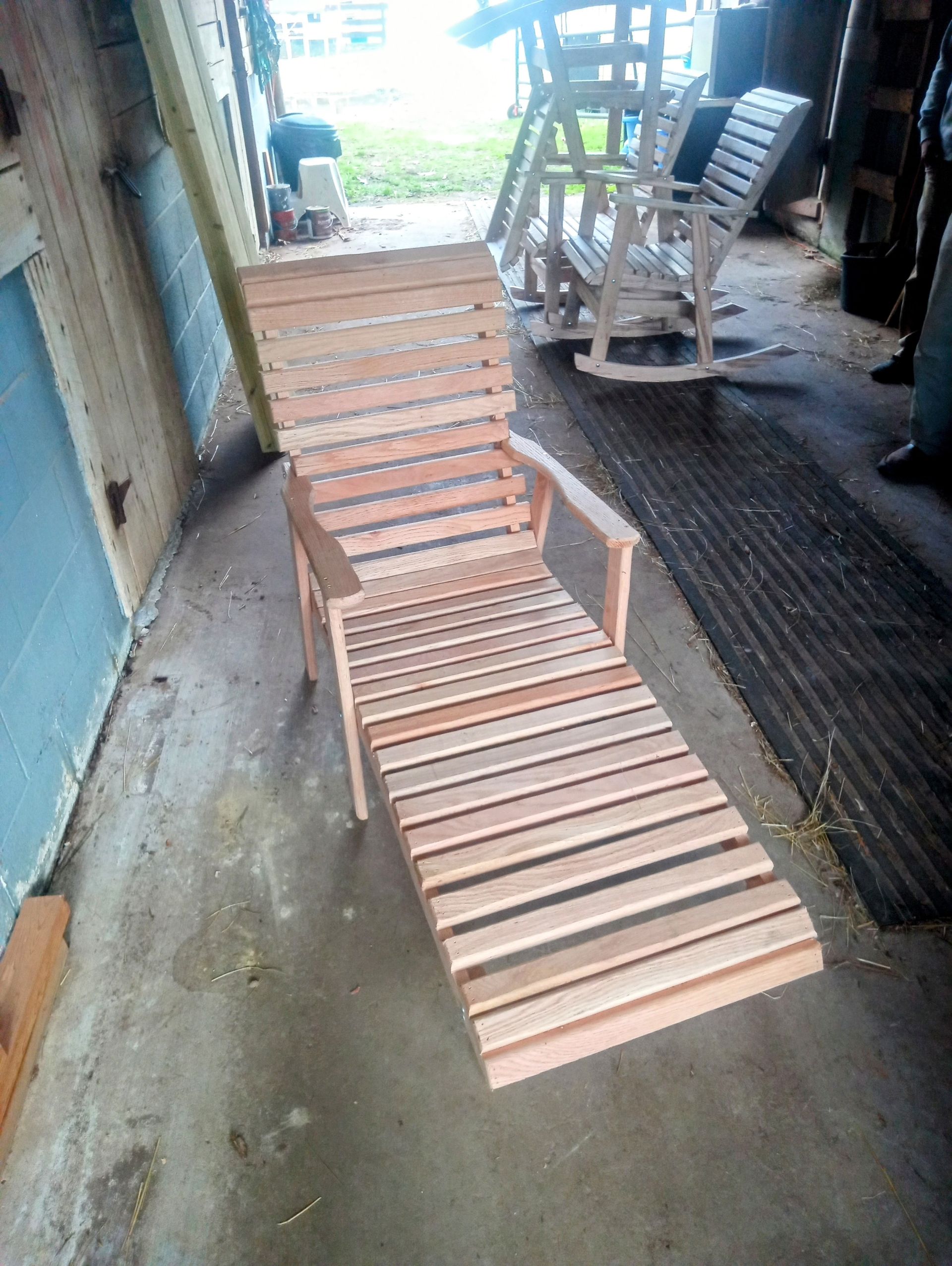 A wooden chair is sitting in a room with other chairs