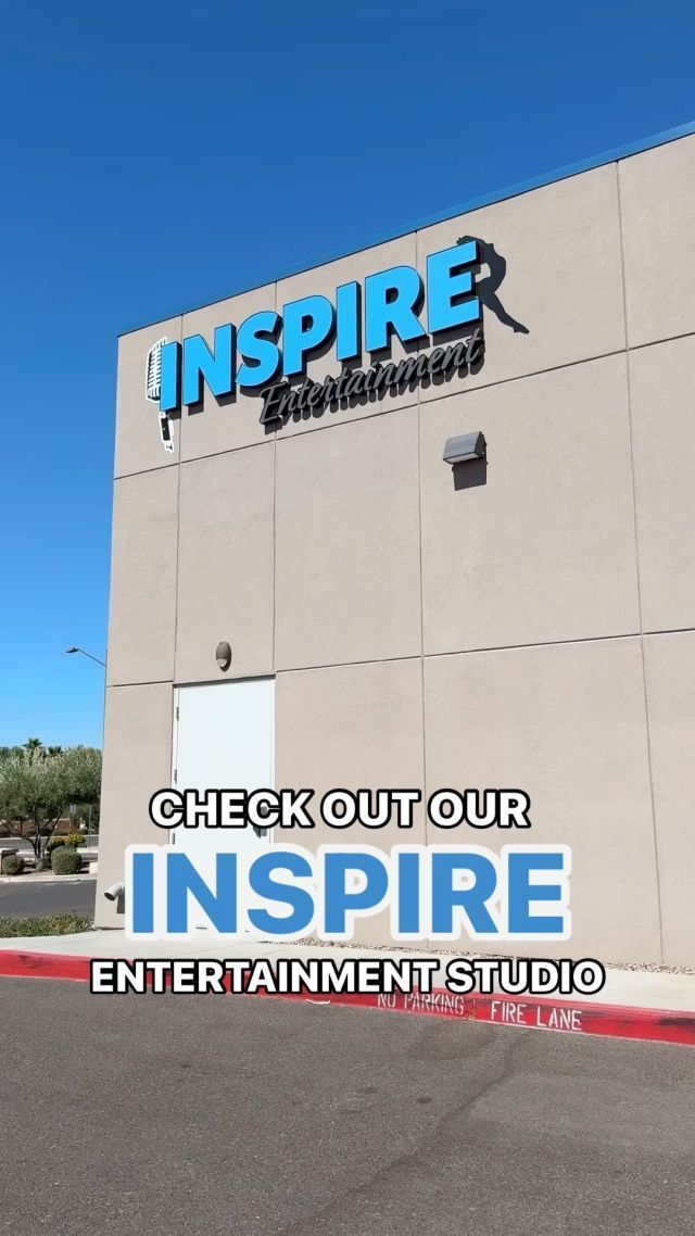 Exterior of Inspire Entertainment Studio building with large blue “INSPIRE” signage on a beige wall