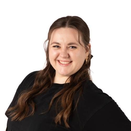 Smiling person in a black top against a white background