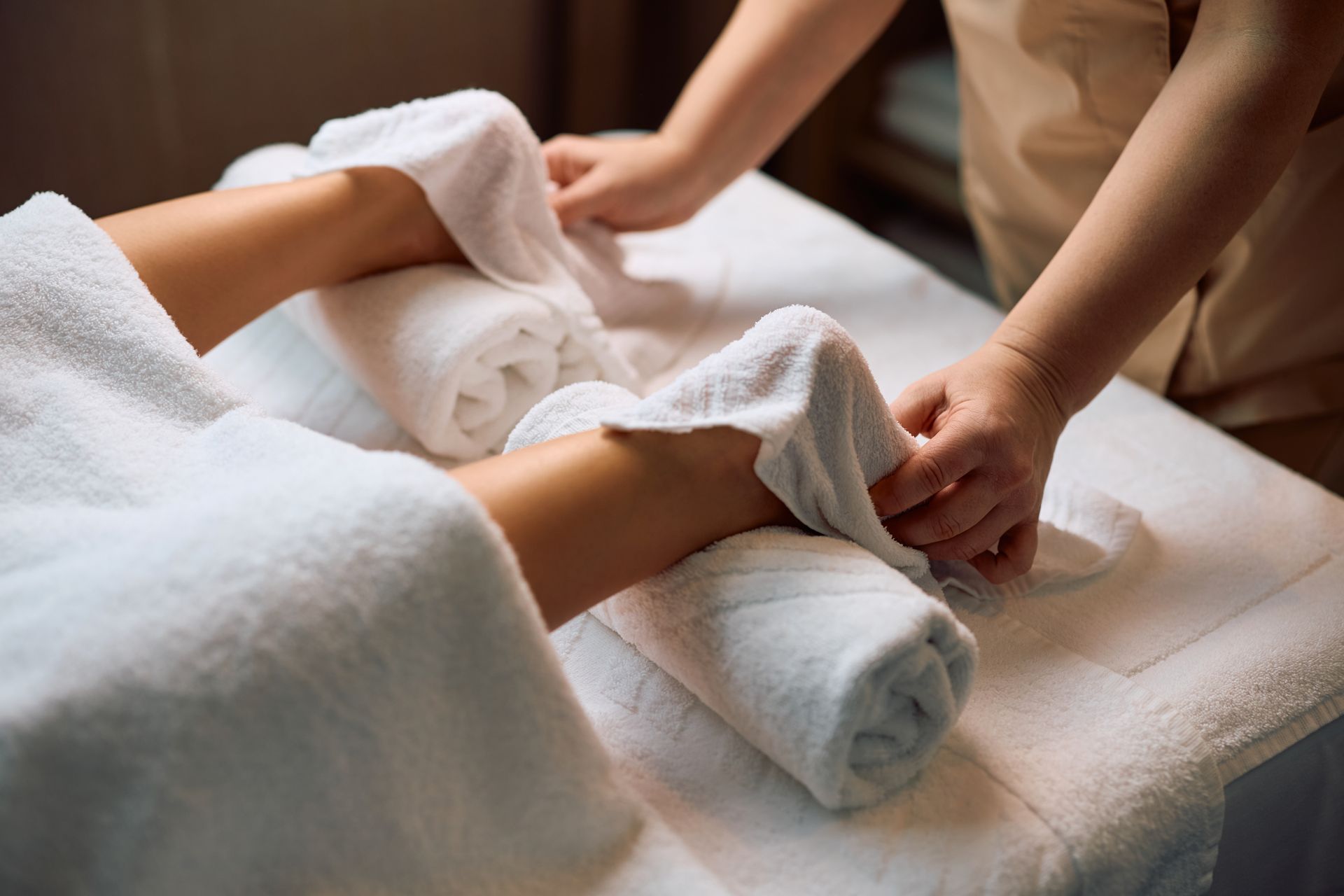 A woman is getting a foot massage from a man.